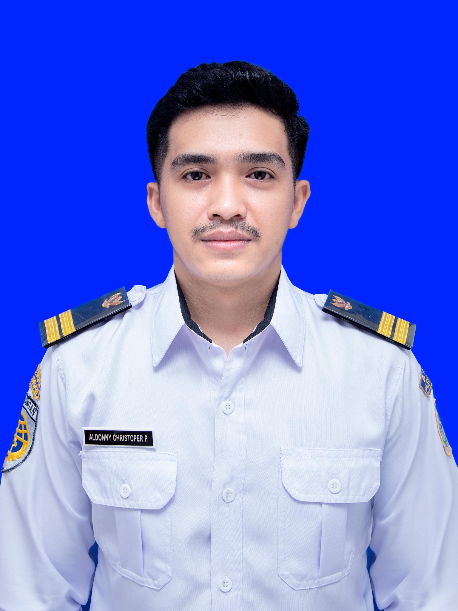 Aldonny wearing a white maritime officer uniform